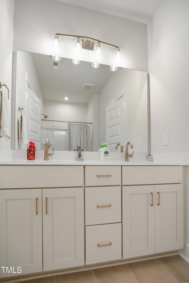 bathroom featuring double vanity, a sink, visible vents, and a shower with curtain