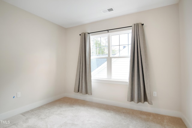 carpeted empty room with baseboards and visible vents