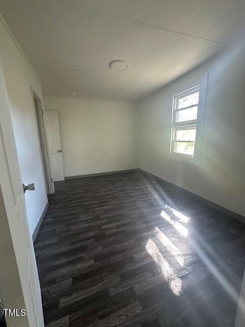 2104 Cecelia Ave, Kinston, NC 28501 - spare room with dark wood-style flooring and baseboards