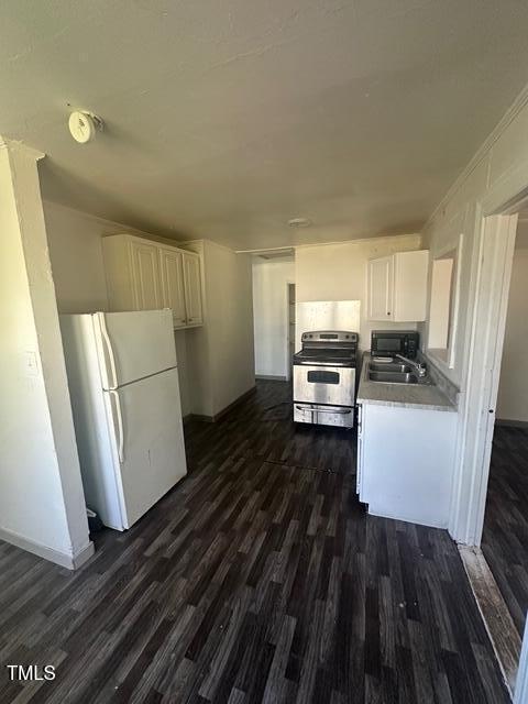 kitchen with white cabinetry, freestanding refrigerator, stainless steel electric range, dark wood-style floors, and black microwave