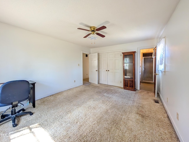 interior space with visible vents, ceiling fan, and baseboards