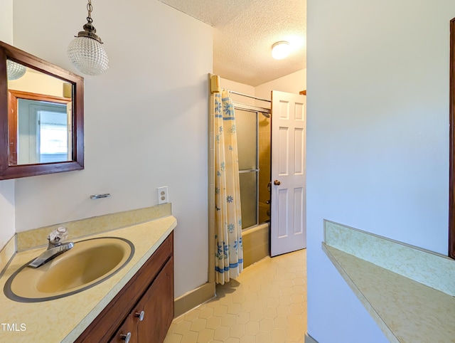 bathroom with tile patterned flooring, vanity, a textured ceiling, and shower / bath combo with shower curtain