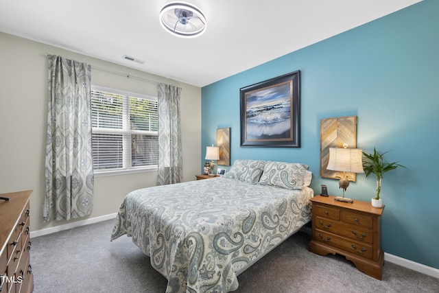 bedroom with baseboards, visible vents, and carpet flooring