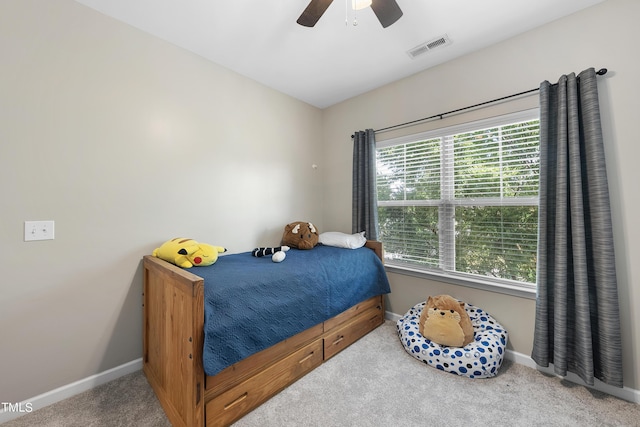 carpeted bedroom with ceiling fan, visible vents, and baseboards