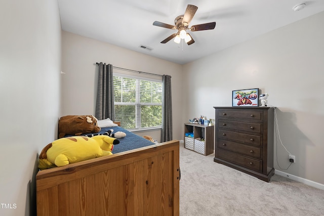 bedroom featuring light carpet, baseboards, visible vents, and a ceiling fan