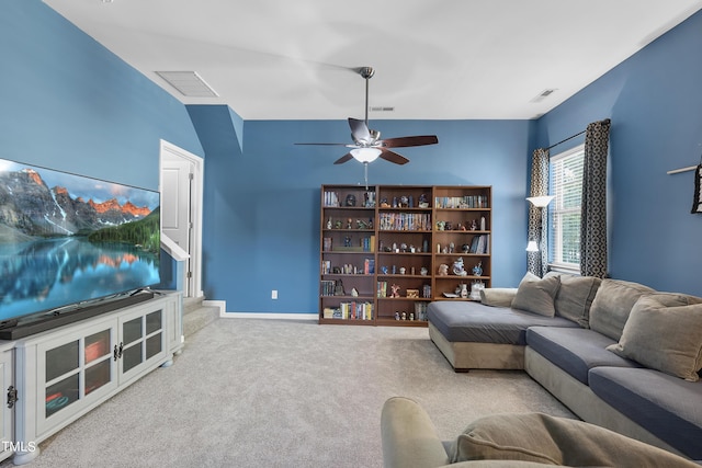 carpeted living room with visible vents, ceiling fan, and baseboards