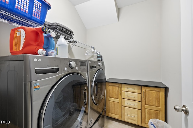 laundry room featuring light tile patterned floors, laundry area, and washer and dryer