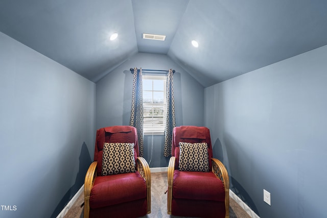 living area with baseboards, visible vents, vaulted ceiling, and carpet flooring