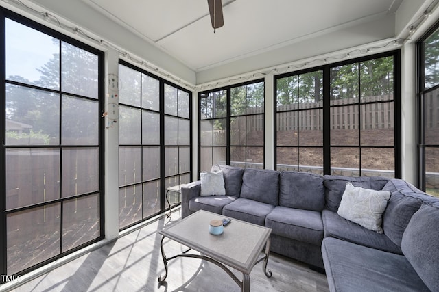 sunroom / solarium featuring a ceiling fan and plenty of natural light