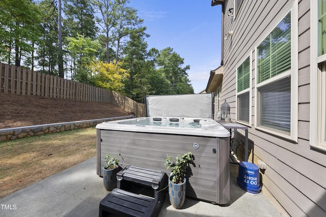 exterior space featuring a fenced backyard and a hot tub