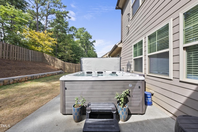 view of patio / terrace with a fenced backyard and a hot tub