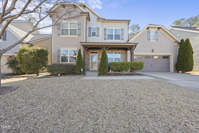 craftsman house with board and batten siding, stone siding, and driveway