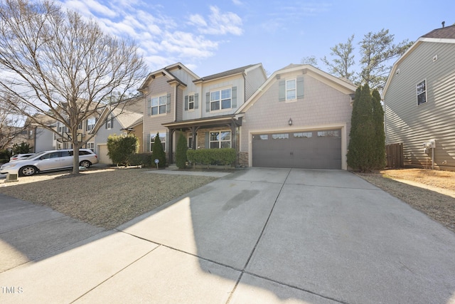 view of front of home featuring driveway, an attached garage, and fence