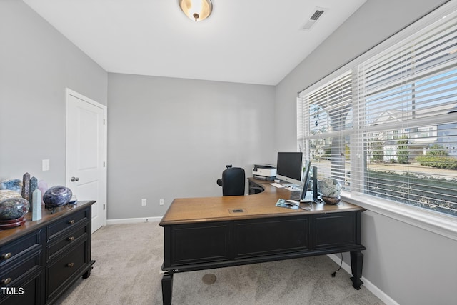 office area featuring baseboards, visible vents, and light colored carpet