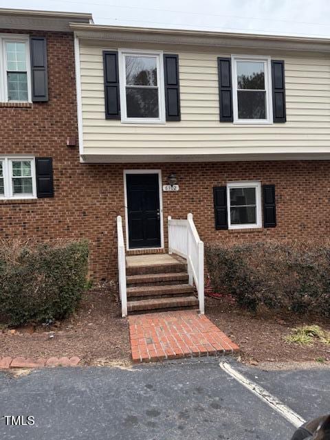 view of front of home featuring brick siding