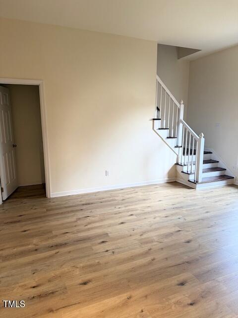 interior space featuring stairway, baseboards, and wood finished floors