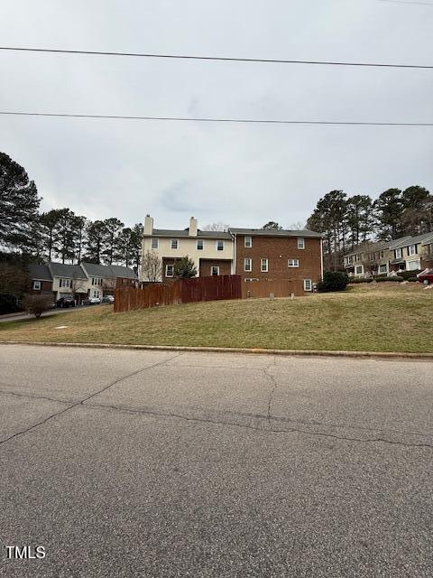 view of front of home featuring a front lawn and fence