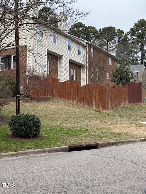 view of front facade with a fenced front yard and a chimney