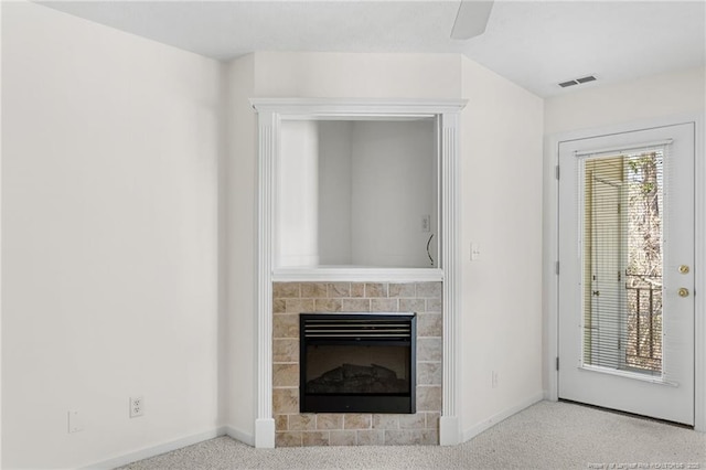 unfurnished living room featuring carpet floors, baseboards, a fireplace, and visible vents