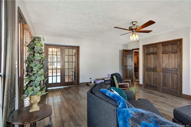 living room with a textured ceiling, french doors, wood finished floors, and baseboards