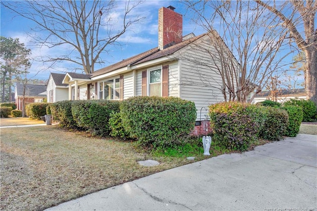 504 W 30th St, Lumberton, NC 28358 - view of home's exterior with a chimney