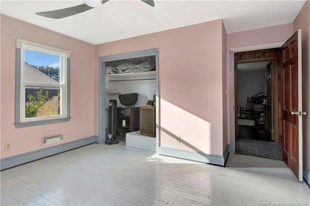 504 W 30th St, Lumberton, NC 28358 - unfurnished bedroom featuring wood finished floors, a closet, and a ceiling fan