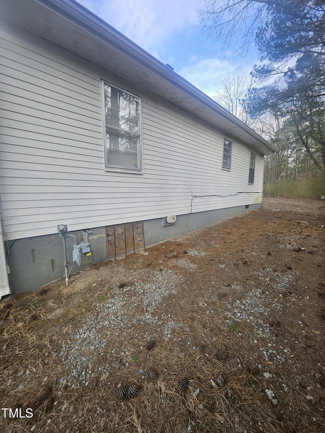 view of side of property with crawl space