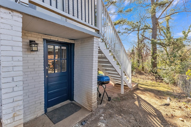 view of exterior entry featuring brick siding