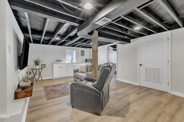 living room featuring light wood-style floors, wood ceiling, visible vents, and baseboards