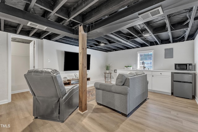 living room with visible vents and light wood-style flooring