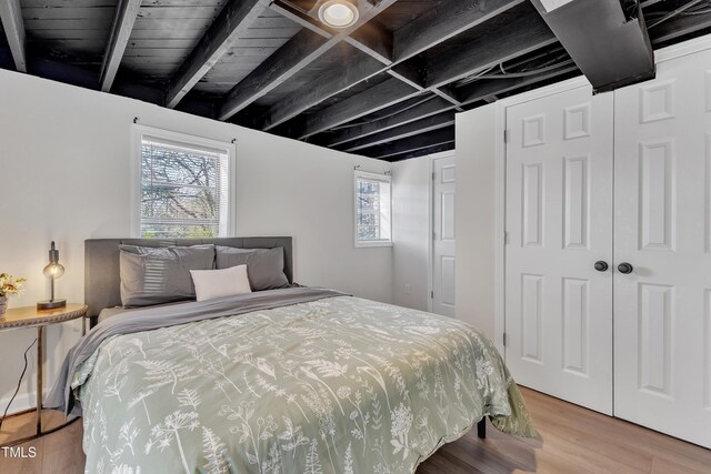 bedroom featuring light wood-style floors and a closet