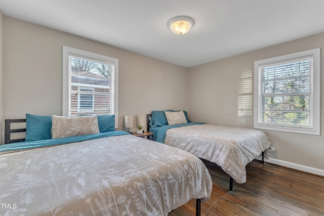 bedroom with baseboards and wood finished floors