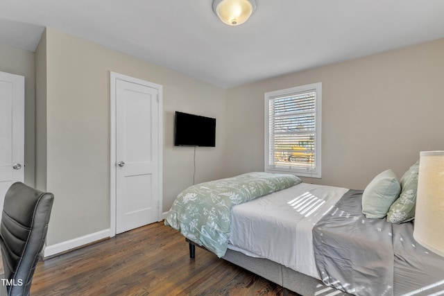 bedroom featuring baseboards and wood finished floors