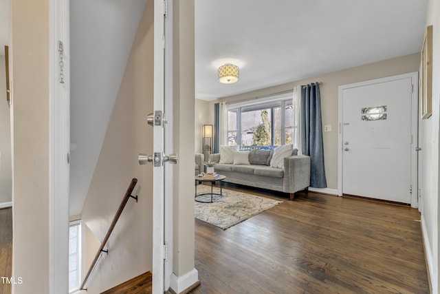 living area featuring wood finished floors, visible vents, and baseboards