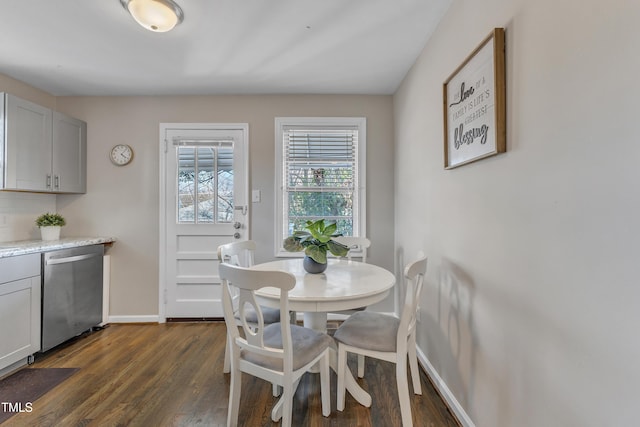 dining area with dark wood finished floors and baseboards