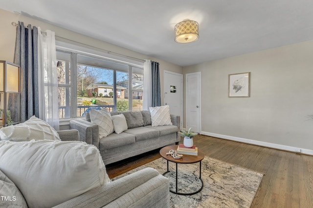 living room with baseboards and wood finished floors