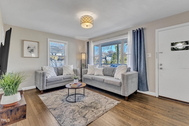 living room with plenty of natural light, wood finished floors, and baseboards