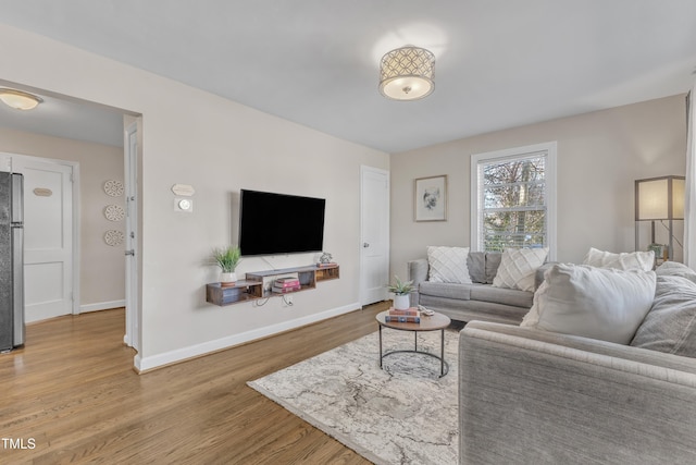 living room featuring baseboards and wood finished floors