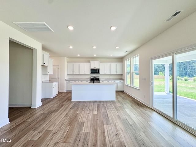 kitchen with visible vents, appliances with stainless steel finishes, and light wood-style flooring