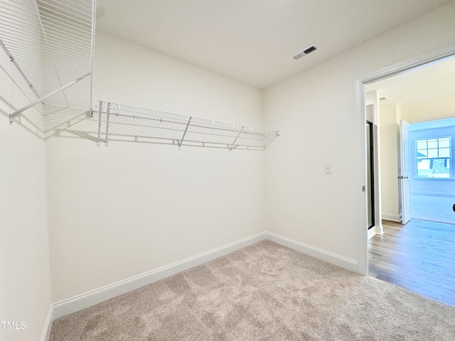 walk in closet featuring carpet floors and visible vents