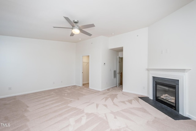 unfurnished living room with lofted ceiling, light colored carpet, a fireplace with flush hearth, visible vents, and baseboards