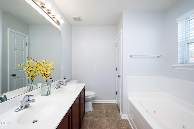 full bath with a whirlpool tub, tile patterned flooring, visible vents, and a sink