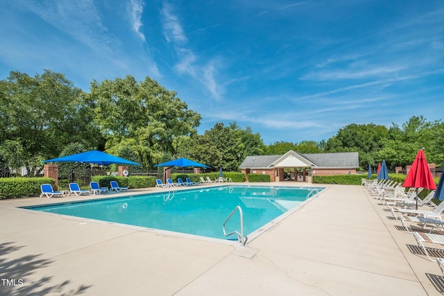 pool with fence and a patio