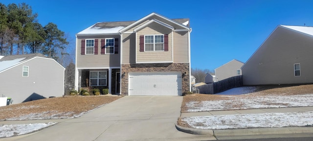 view of front facade with a garage, stone siding, and concrete driveway