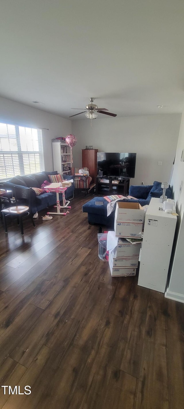 interior space with wood finished floors and a ceiling fan