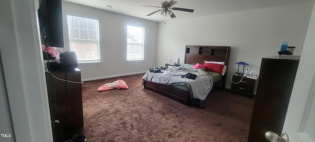 carpeted bedroom with a ceiling fan, visible vents, and baseboards