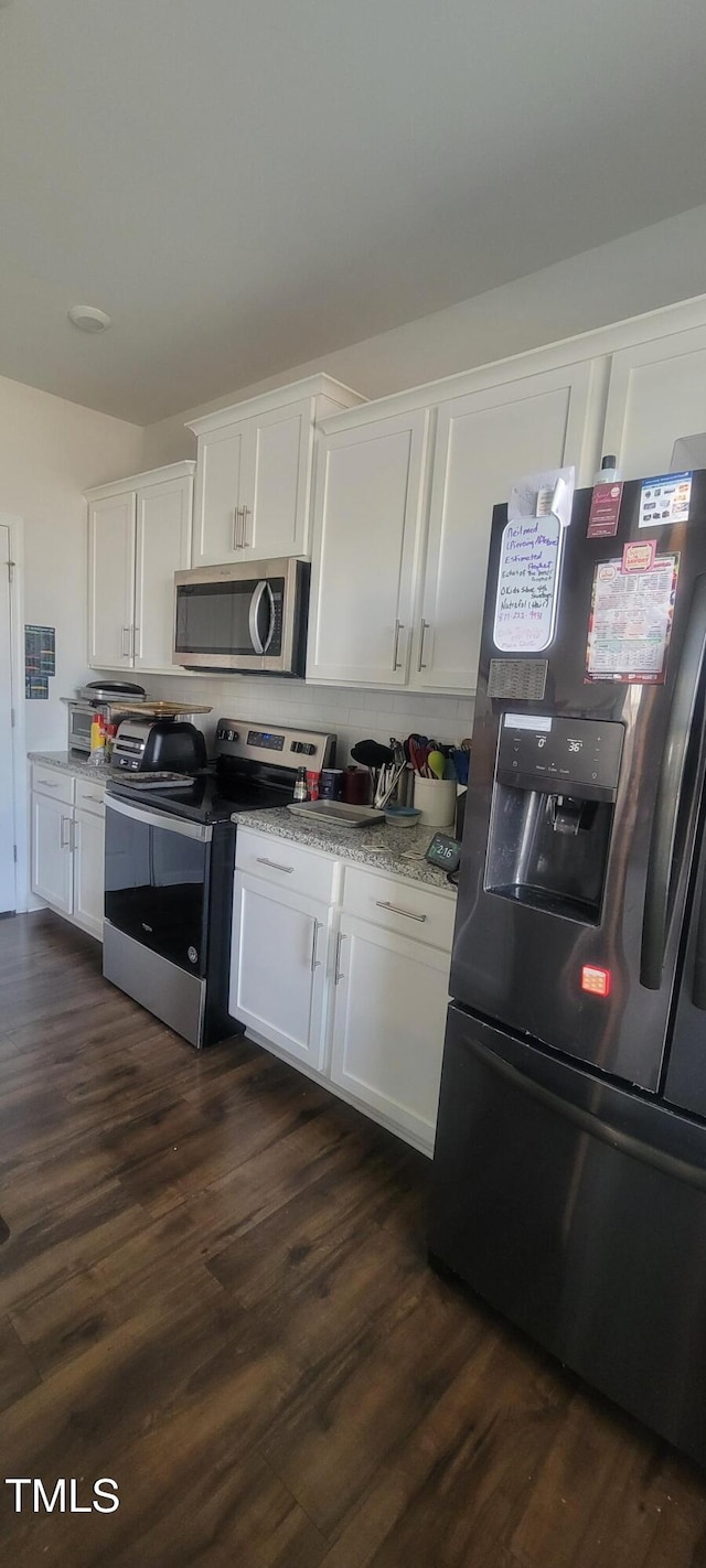 kitchen featuring white cabinetry, appliances with stainless steel finishes, and dark wood-style flooring