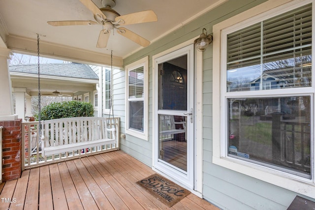 wooden deck with covered porch and a ceiling fan