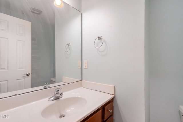 bathroom featuring toilet and vanity