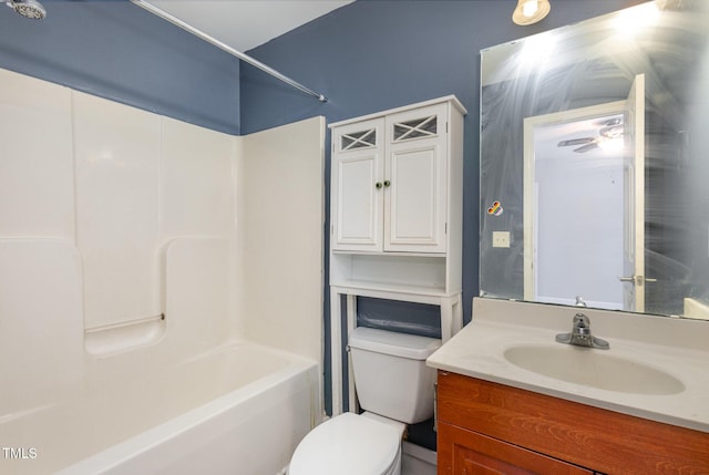 bathroom with toilet,  shower combination, and vanity